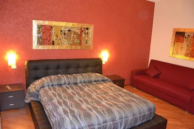 a bedroom with a bed and a couch at Affittacamere Mazzini in Rome