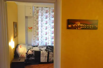 a bedroom with a bed and a window with a curtain at Affittacamere Mazzini in Rome