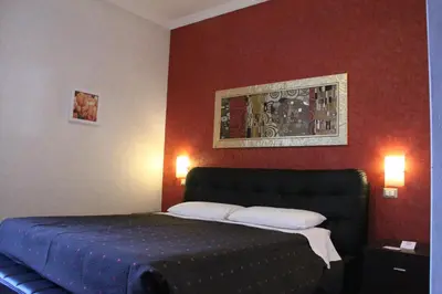 a bedroom with a bed with two pillows on it at Affittacamere Mazzini in Rome