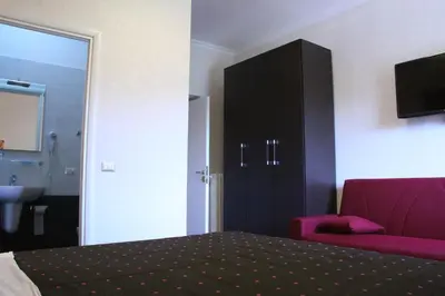 a bedroom with a bed and a cabinet and a sink at Affittacamere Mazzini in Rome