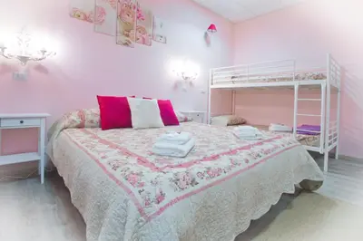 a bedroom with a bed and a bunk bed at Vatican Rooms Accommodation in Rome