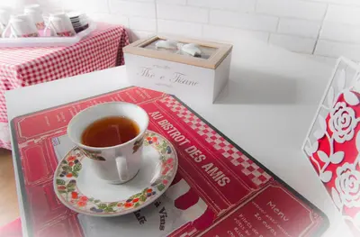 a cup of tea on a plate next to a book at Vatican Rooms Accommodation in Rome