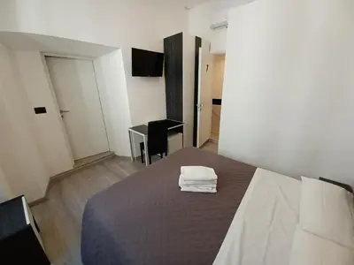 a bedroom with a bed with towels on it at Hotel Mimosa Pantheon in Rome