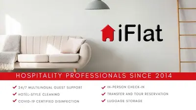 a white living room with a white couch and a sign at iFlat Trastevere Bianca's House in Rome