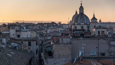 a view of a city with a cathedral and buildings at Antica Dimora Delle Cinque Lune in Rome