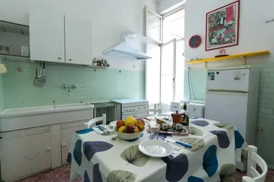 a kitchen with a table with a bowl of fruit on it at old corallo in Rome