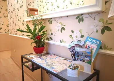 a table in a room with flowers on the wall at Relais Villa Fiorelli in Rome