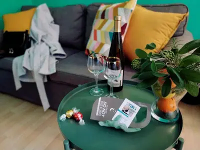 a green table with two glasses and a bottle of wine at Relais Villa Fiorelli in Rome