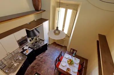 an overhead view of a kitchen with a table and a stove at Campo Dei Fiori Home in Rome