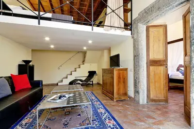 a living room with a couch and a table at Campo Dei Fiori Home in Rome