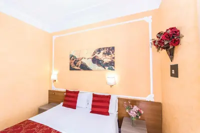 a hotel room with a bed with red and white pillows at Downtown Accommodation in Rome