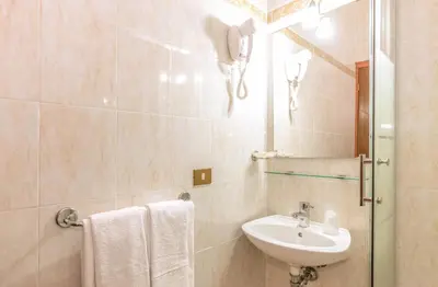 a bathroom with a sink and a mirror at Downtown Accommodation in Rome