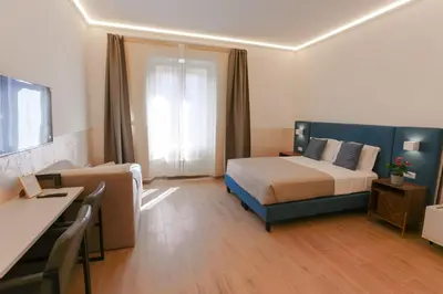 a hotel room with a bed and a desk and a room at B&B Smart Rooms in Rome