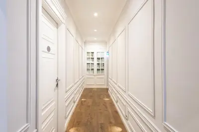 a hallway with white walls and a hard wood floor at La Maison di Sant'Anna in Rome