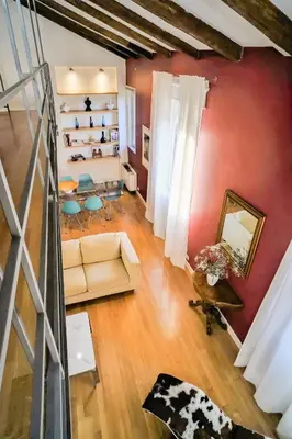 a living room with a couch and a mirror at Appartamento a Castel Sant'Angelo con terrazza in Rome