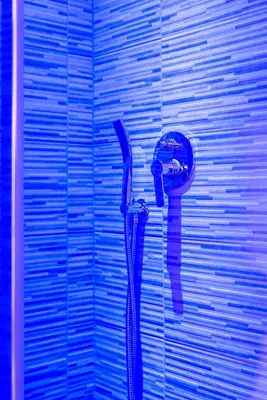 a blue wall with a hair dryer on it at chèri luxury suite in Rome