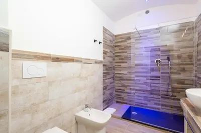 a bathroom with a shower and a toilet and a sink at chèri luxury suite in Rome