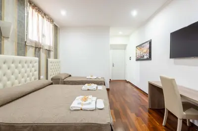 a living room with a couch and a tv at chèri luxury suite in Rome