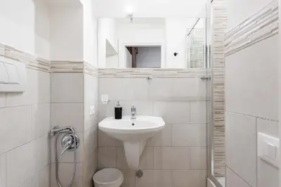 a white bathroom with a sink and a mirror at chèri luxury suite in Rome