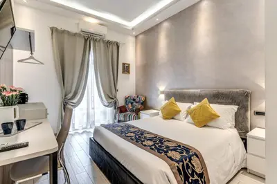 a hotel room with a bed and a desk at Rose Suite in Rome