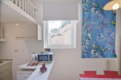 a kitchen with a counter with a microwave and a window at Colosseum relax family apartament in Rome