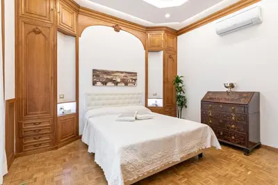 a bedroom with a bed and a dresser at First Class Rome Apartments in Rome