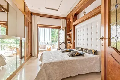 a bedroom with a bed and a large window at First Class Rome Apartments in Rome