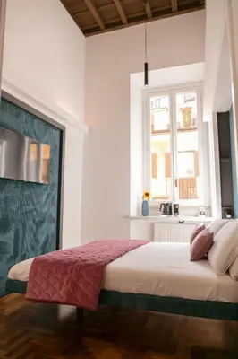 a bedroom with a bed and a window at Hadrianus Temple Suites - The Venue Collection in Rome