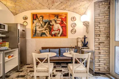a living room with a table and a painting on the wall at Nakissa Inn in Rome