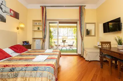 a bedroom with a bed and a desk and a table at InternoUno Deluxe in Rome