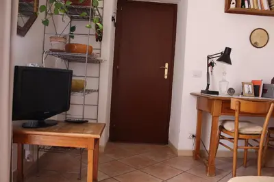 a television sitting on a table next to a door at Hazelrome apartment in Rome