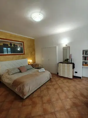 a bedroom with a large bed and a tiled floor at Piramide Gold in Rome