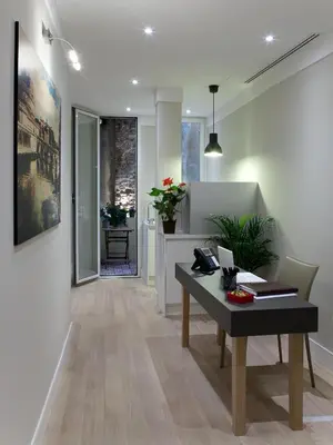 a living room with a table and a dining room at Regola Suite in Rome