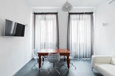a dining room with a table and chairs and a couch at Claudio My House in Rome
