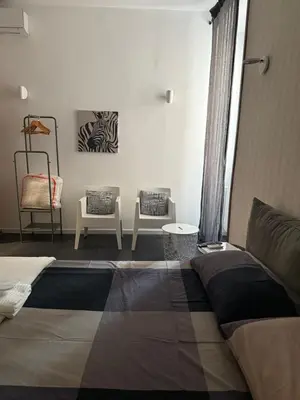 a white dresser with a tv and a wall at Claudio My House in Rome