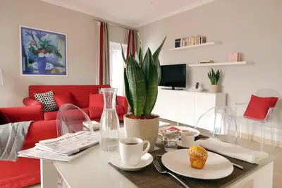 a living room with a table with a plant on it at Piazzetta Margutta - My Extra Home in Rome