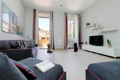 a living room with two couches and a tv at Piazzetta Margutta - My Extra Home in Rome
