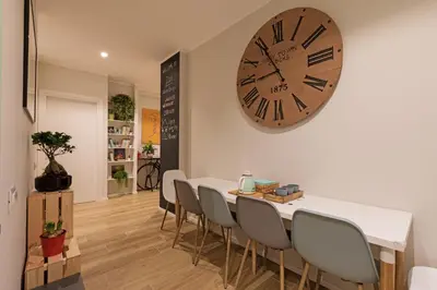 a dining room with a table and a large clock on the wall at Ziani Vatican Boutique in Rome