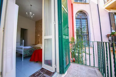 a balcony with a door open to a room at Hotel Pisa in Rome