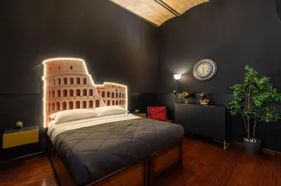a bedroom with a bed and a chair and a plant at Majestic Trastevere in Rome