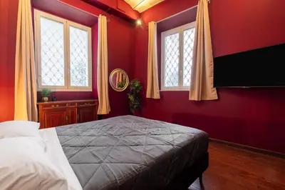 a bathroom with a sink and a bed and a mirror at Majestic Trastevere in Rome