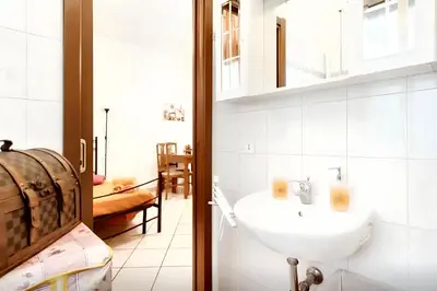 a bathroom with a sink and a mirror at Comfortable studio in Rome 40.2 m² with wifi in Rome