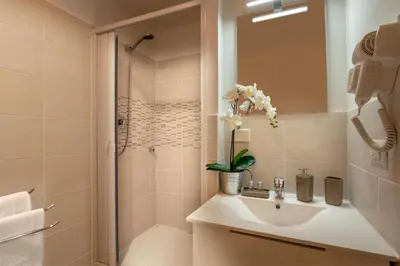 a bathroom with a sink and a shower at Domus Veneto Rome in Rome