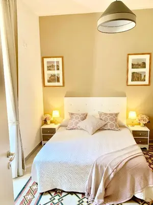 a bedroom with a large bed with two night stands at Mama Roma Domus in Rome