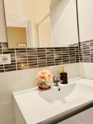 a bathroom with a white sink and a mirror at Mama Roma Domus in Rome