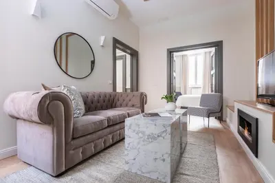 a living room with a couch and a mirror at Louly Spanish Steps in Rome