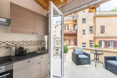 a kitchen with a balcony with a view of a building at Royal Piazza di Spagna in Rome