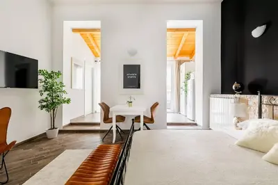 a bedroom with a bed and a table and chairs at Royal Piazza di Spagna in Rome