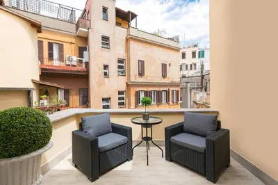 a balcony with two chairs and a table on a balcony at Royal Piazza di Spagna in Rome