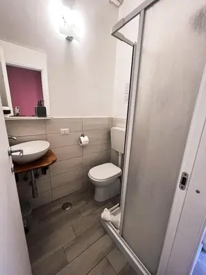 a bathroom with a toilet and a sink at Novaroma by Local Domus in Rome